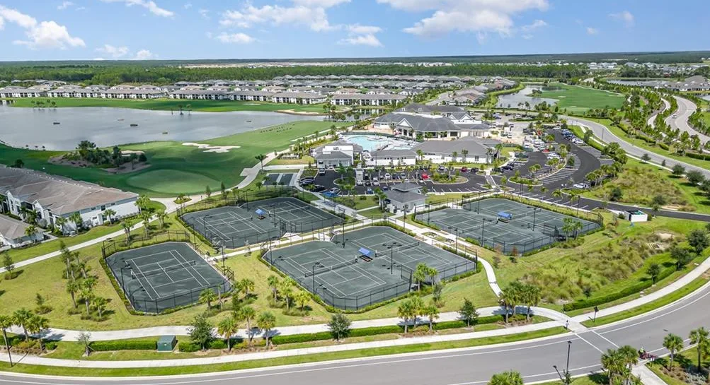 Aerial of the tennis courts, clubhouse, golf course and lake at Babcock National