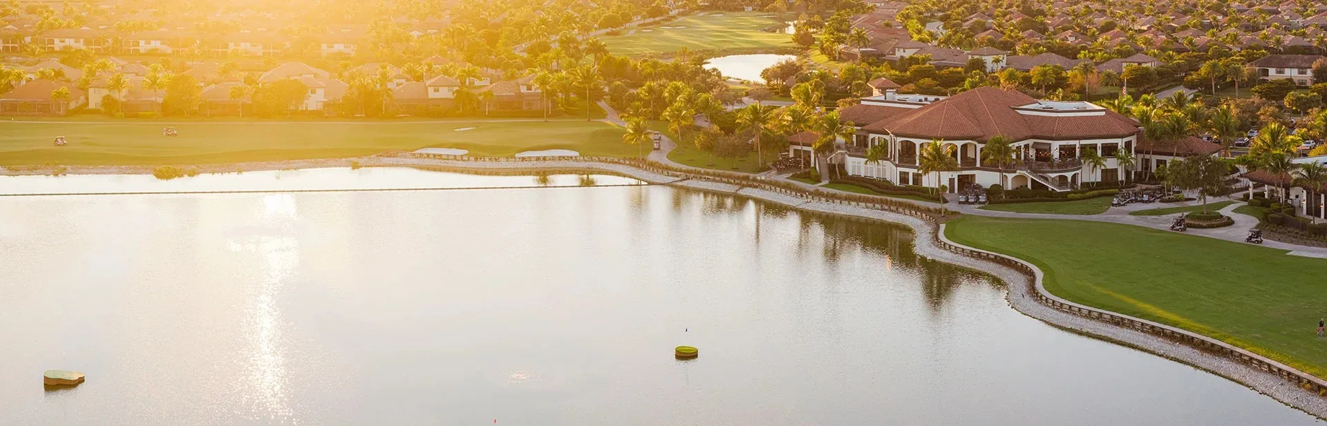 Clubhouse across the lake at sunrise, Bonita National (official club site).