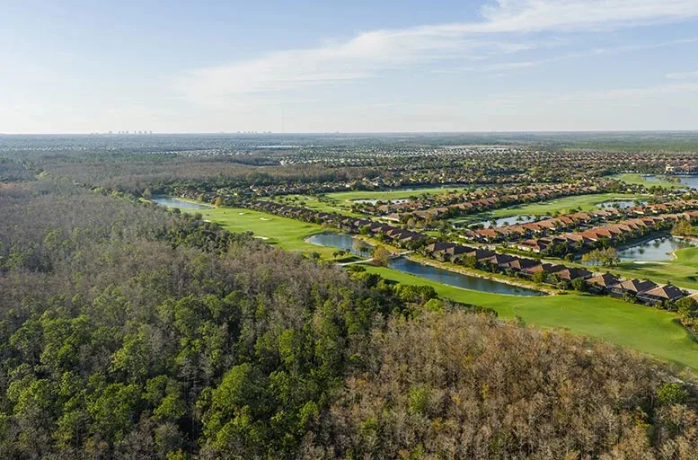 Aerial of Bonita National homes, lakes and golf beside the CREW preserve.