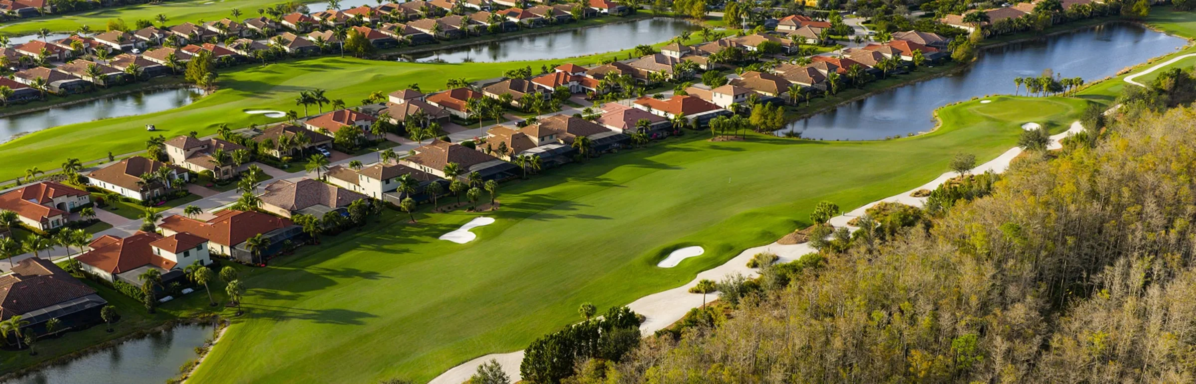 Aerial of homes along the golf course at Bonita National (official club site).