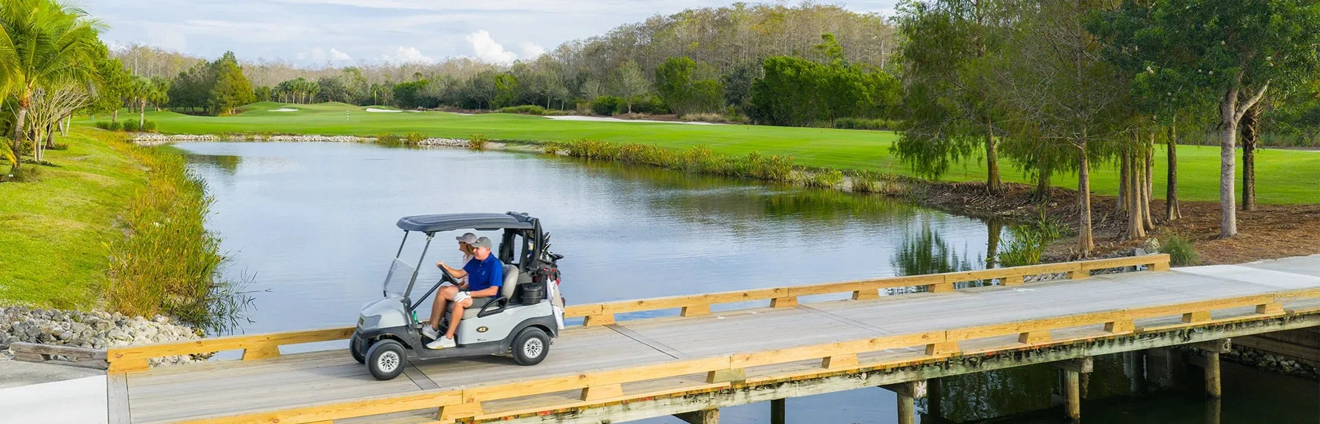 Golf cart crossing a bridge on the Bonita National course (official club site).