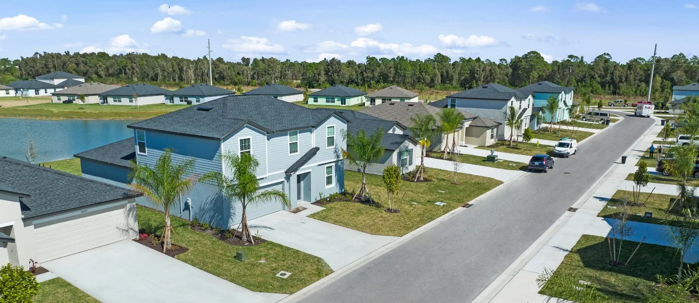 Aerial streetscape of new homes along a lake at Crane Landing, North Fort Myers (official Lennar site).