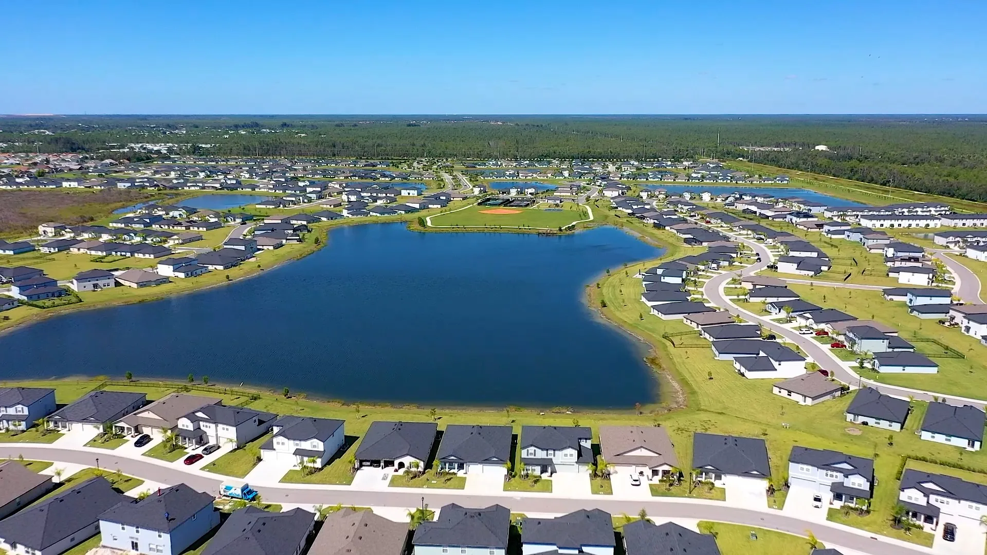 Aerial of the lake and neighborhoods at Crane Landing, North Fort Myers (official Lennar site).