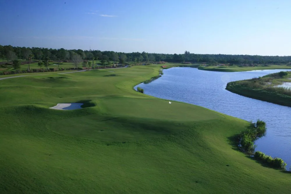 Fairway curving along a lake at TPC Treviso Bay, Naples.