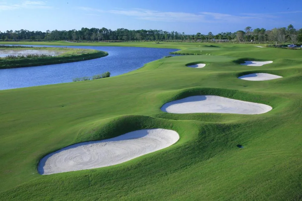 Bunkered green beside a lake at TPC Treviso Bay, Naples.
