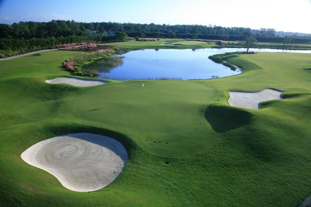 Elevated view of a bunkered green and lake at TPC Treviso Bay, Naples.