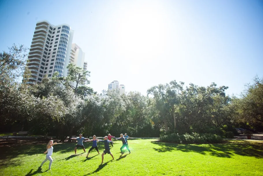 High-rise residence above a park lawn.