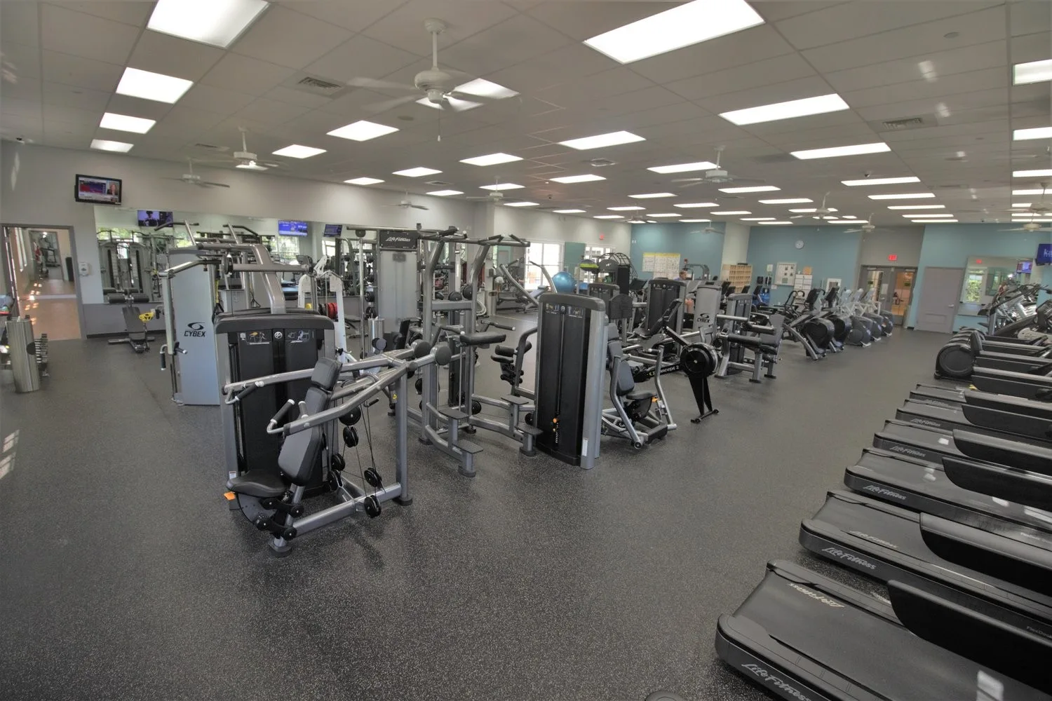 Fitness center with cardio and strength equipment at Pelican Landing (official community site).