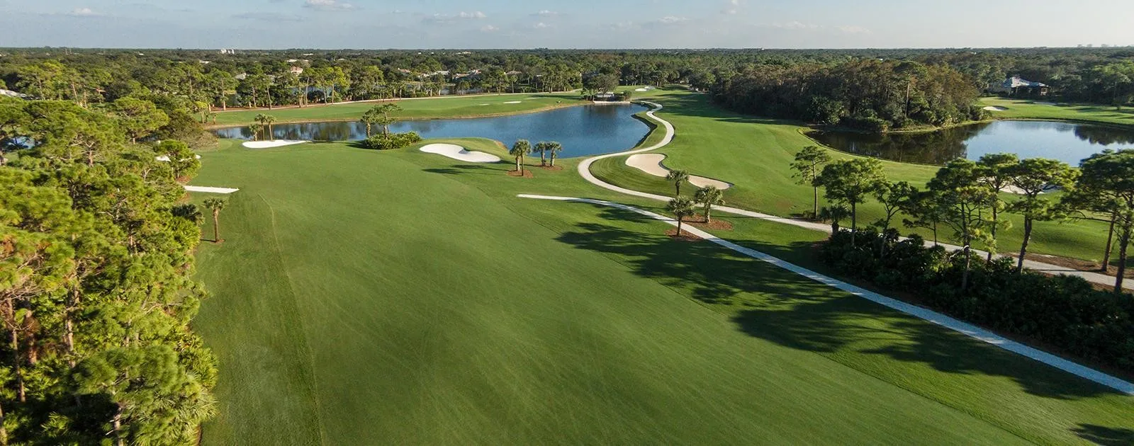 Aerial golf fairways lakes and bunkers at Pelican Landing (official community site).