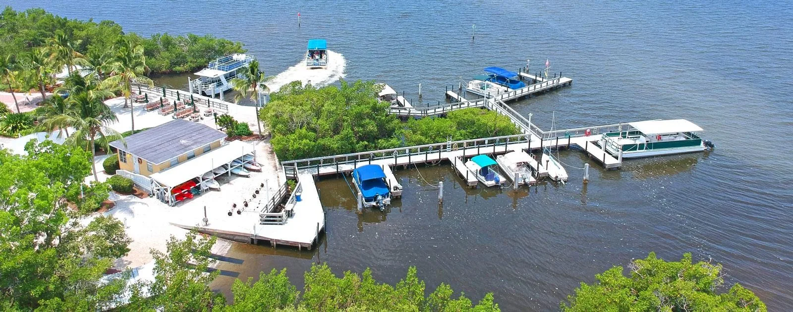 Marina docks kayaks and ferry boats amenity at Pelican Landing (official community site).