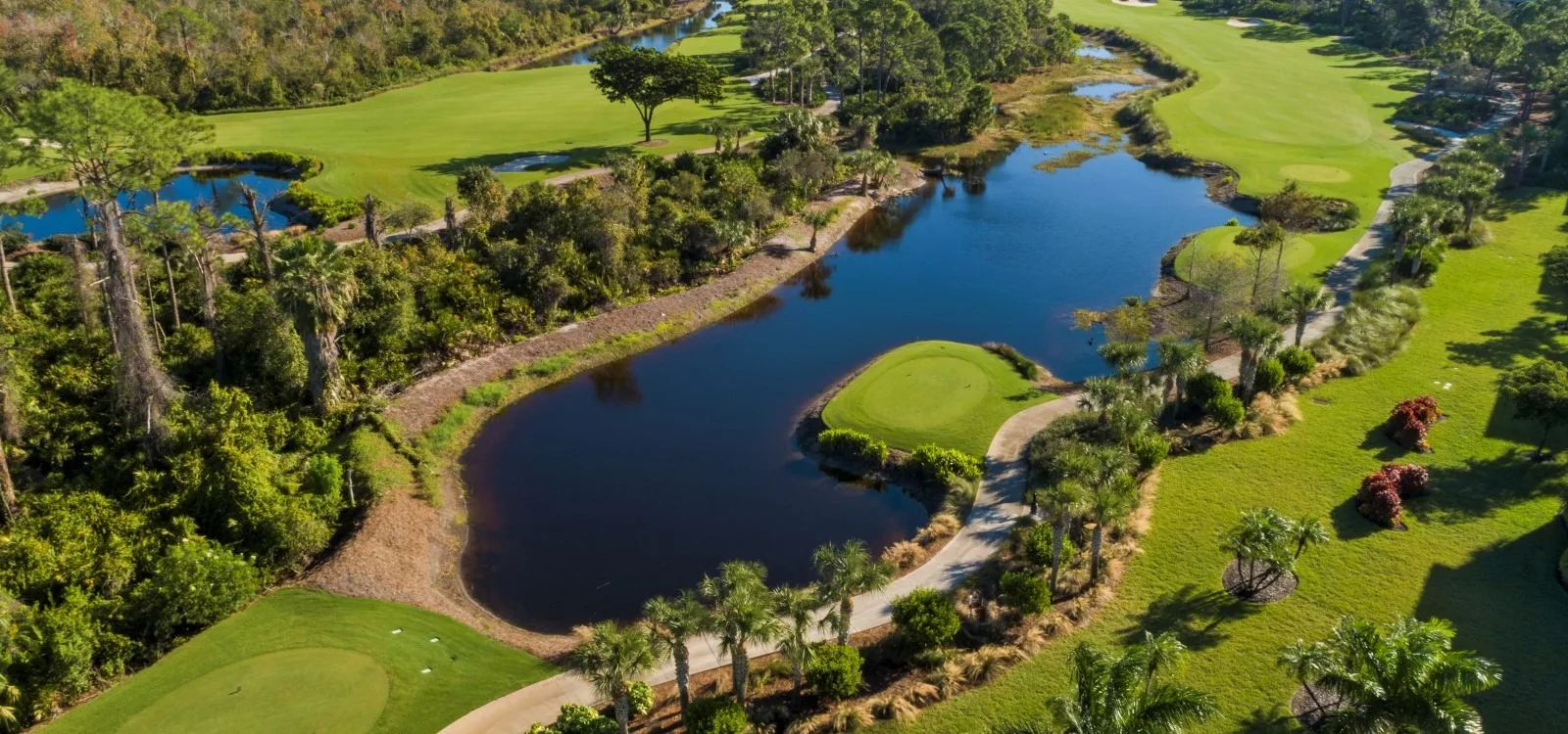 Aerial lake and golf course overview at The Colony, Bonita Springs (official).