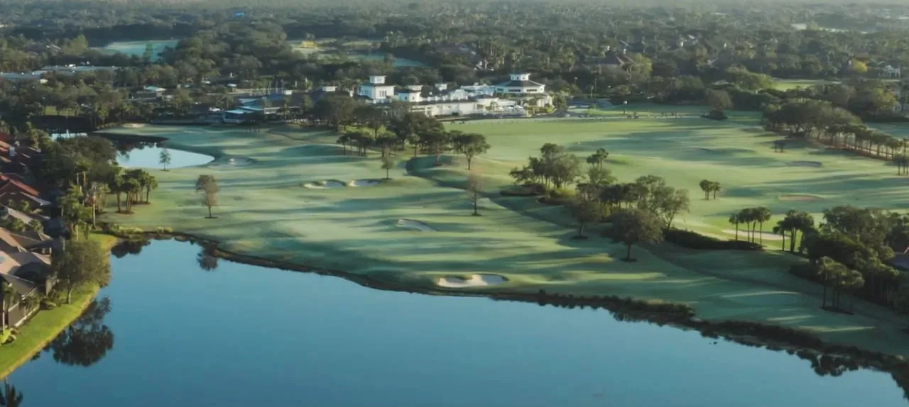 Aerial of a lakeside golf hole at Shadow Wood Country Club, Estero (official club site).