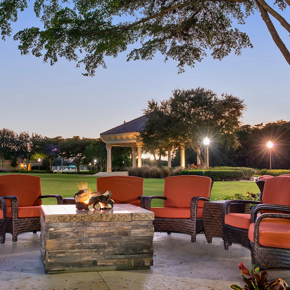Evening fire-pit patio amenity at Lighthouse Bay (official association).