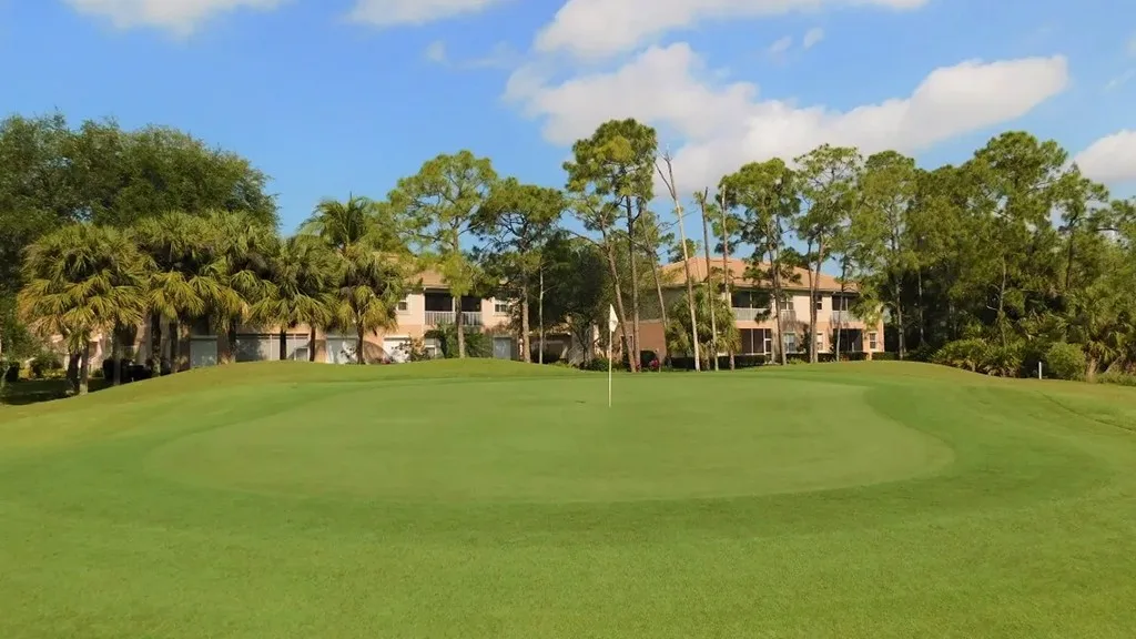 Golf hole with condo skyline beyond at Spanish Wells, Bonita Springs (official).