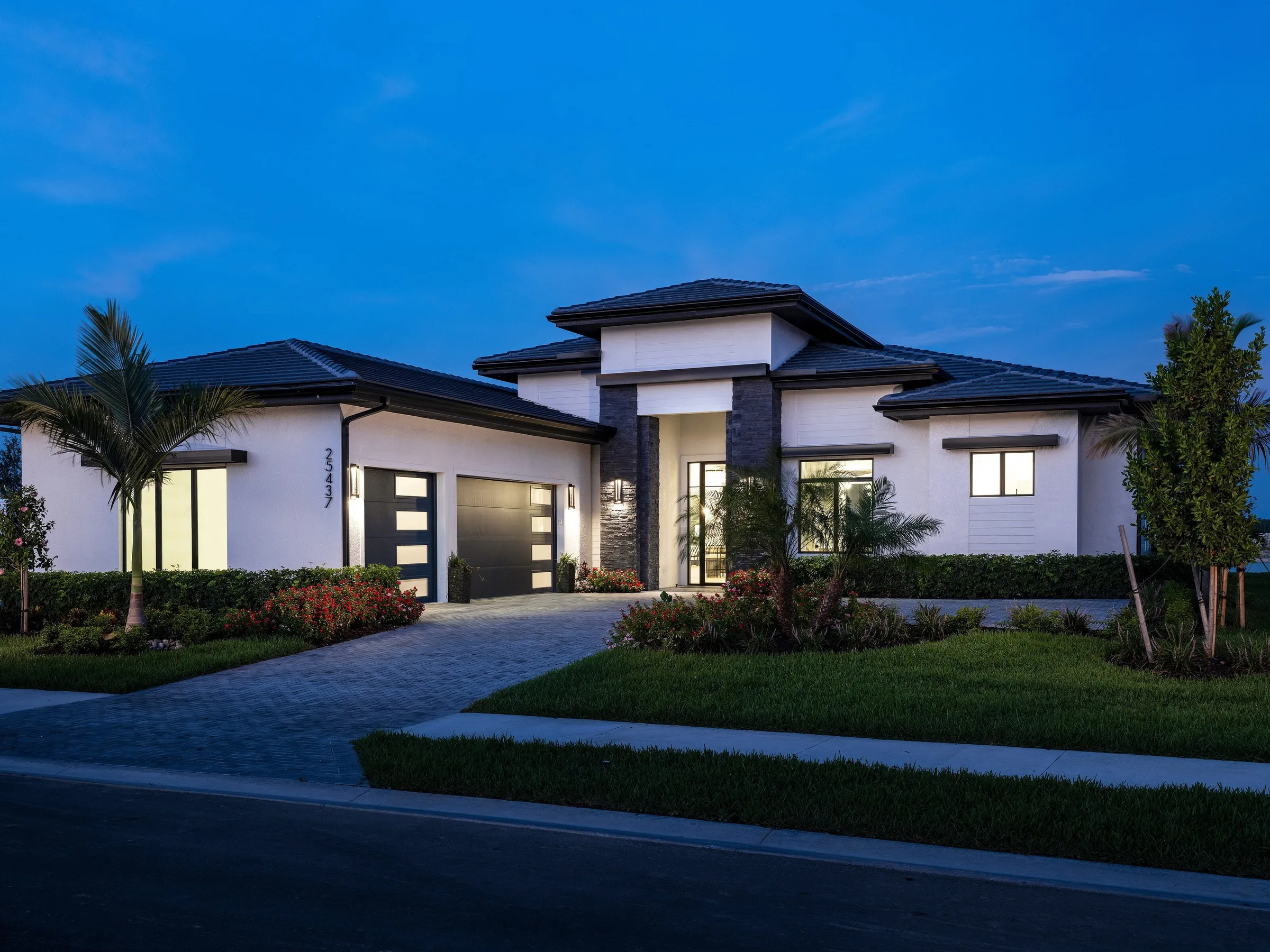 Madison II home by Stock Luxury Homes at Vivid Shores at dusk.