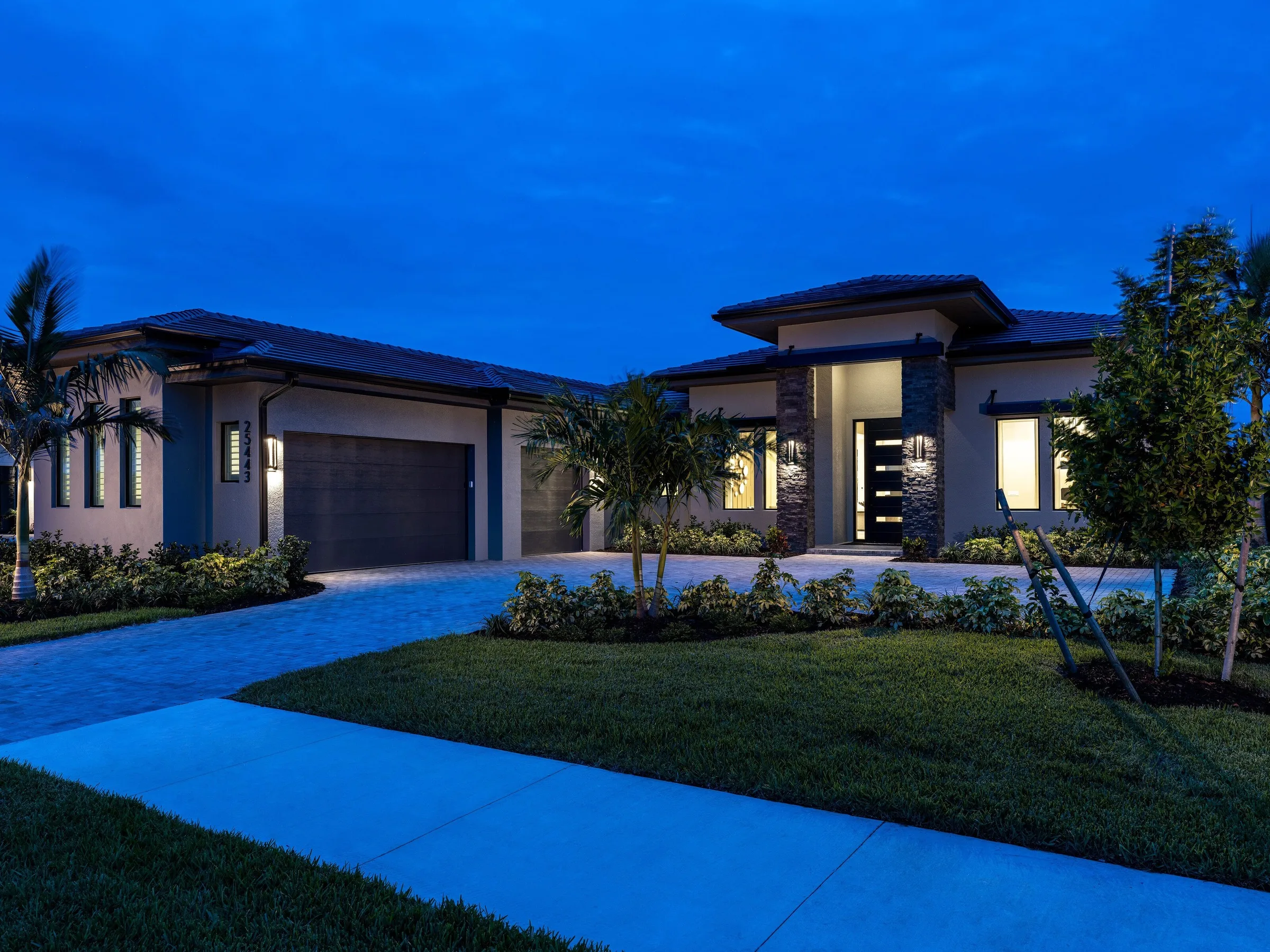 Sterling IV home by Stock Luxury Homes at Vivid Shores at dusk.