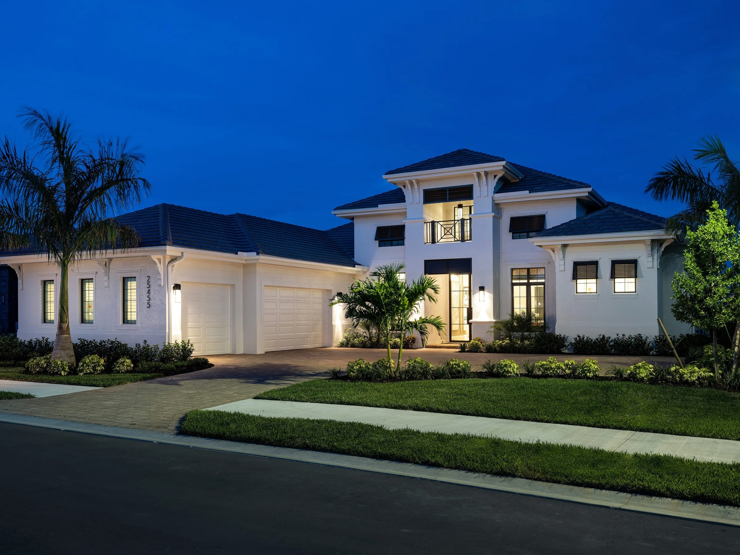 Margo IV home by Stock Luxury Homes at Vivid Shores at dusk.