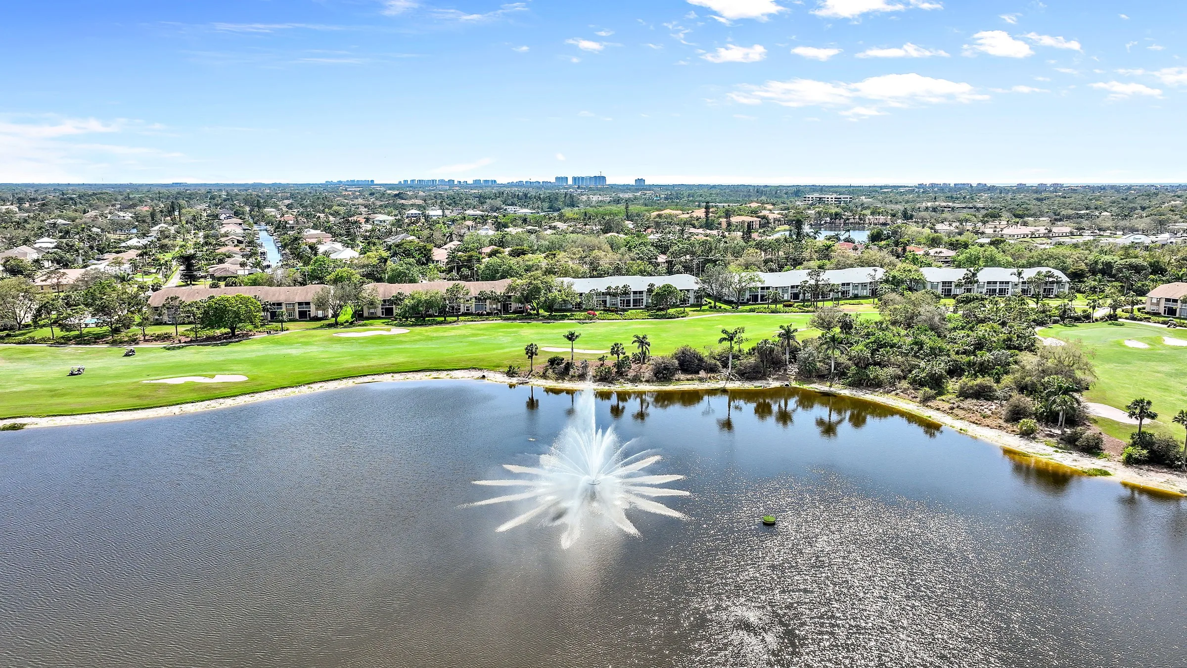Aerial lake, fountain and golf course at Highland Woods (official club site).