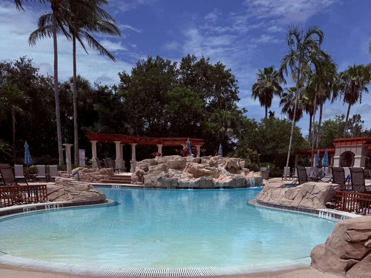 Zero-entry pool with rock waterfall at Palmira Golf and Country Club (official mypalmira.org).
