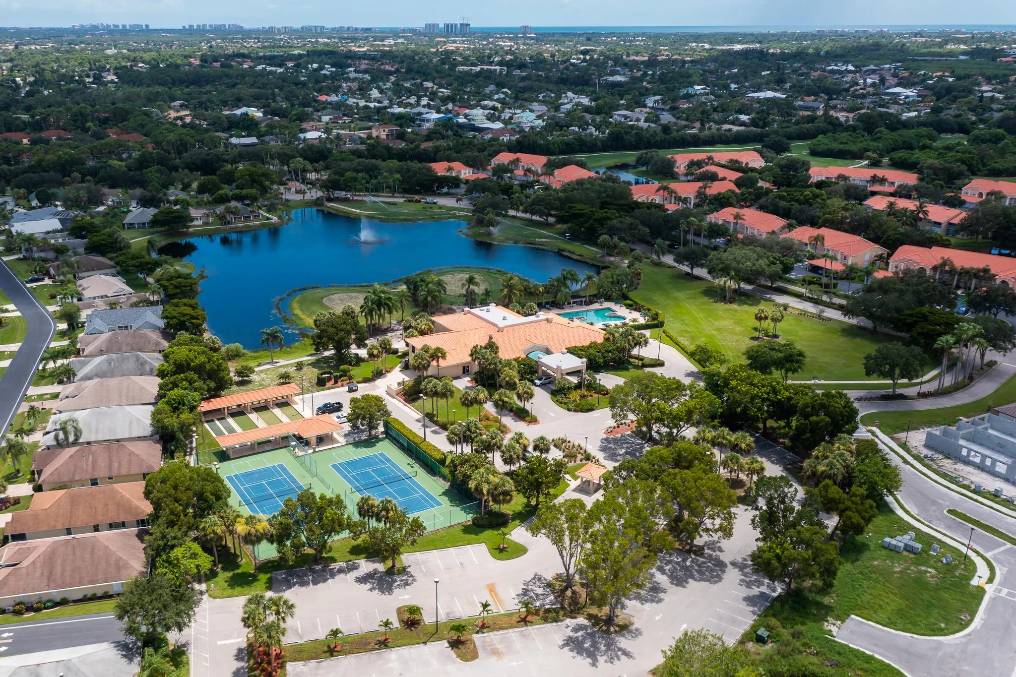 Aerial view of the clubhouse, courts, and amenities at Bonita Fairways (official association).