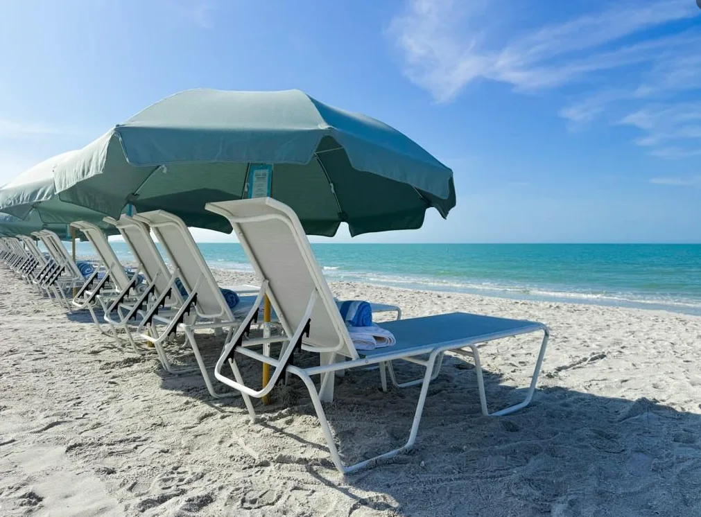Mediterra beach club chairs and umbrellas on the Gulf