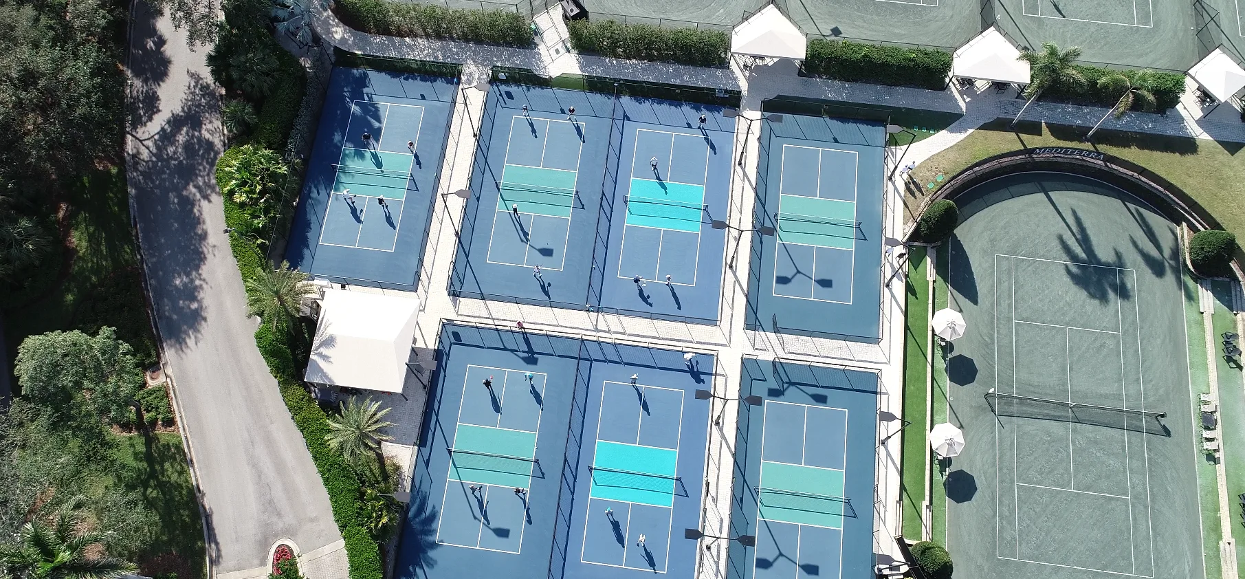 Aerial view of the tennis and pickleball courts at The Club at Mediterra, Naples.