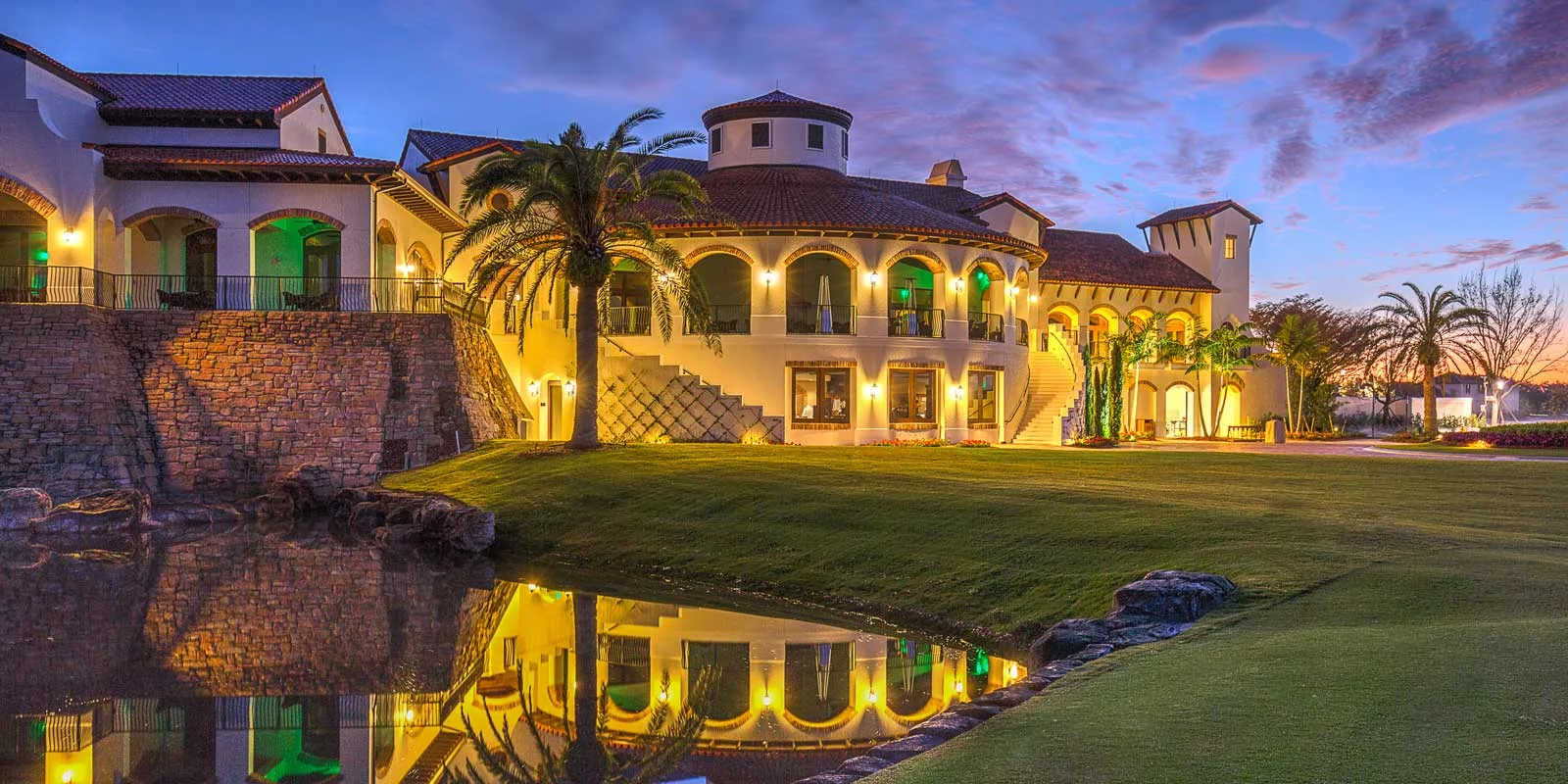 Clubhouse reflected in the water at dusk, Talis Park Golf Club, Naples.
