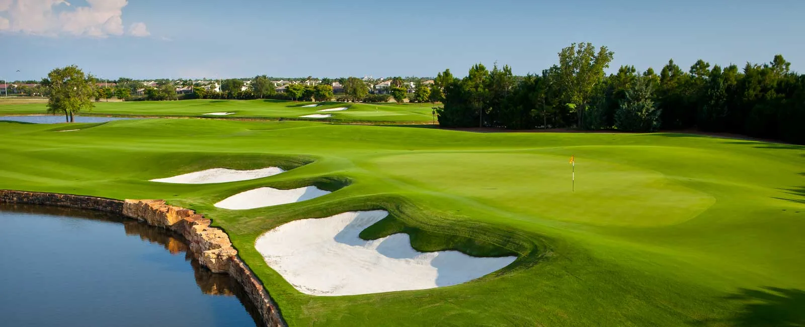Bunkered green beside a lake at Talis Park Golf Club, Naples.