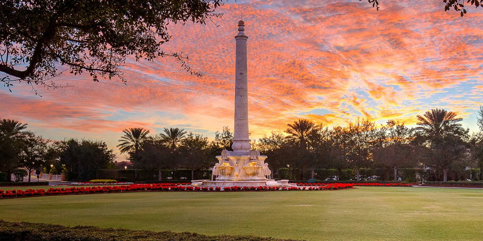 Landmark obelisk and fountain at sunset, Talis Park, Naples.