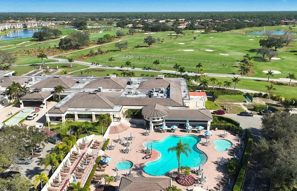 Vineyards Country Club clubhouse and pool from above, with the golf course beyond
