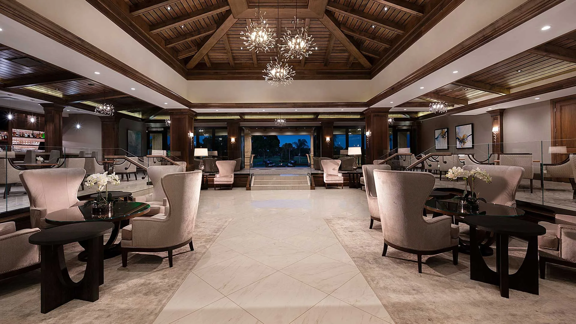 Clubhouse lounge interior at dusk, Vineyards Country Club Naples (official).