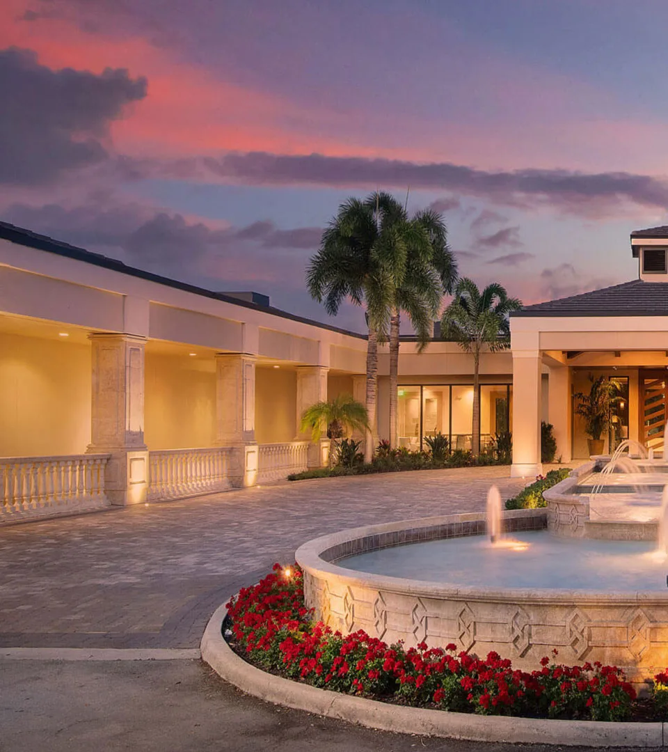 Clubhouse entrance and fountain at sunset, Vineyards Country Club, Naples.
