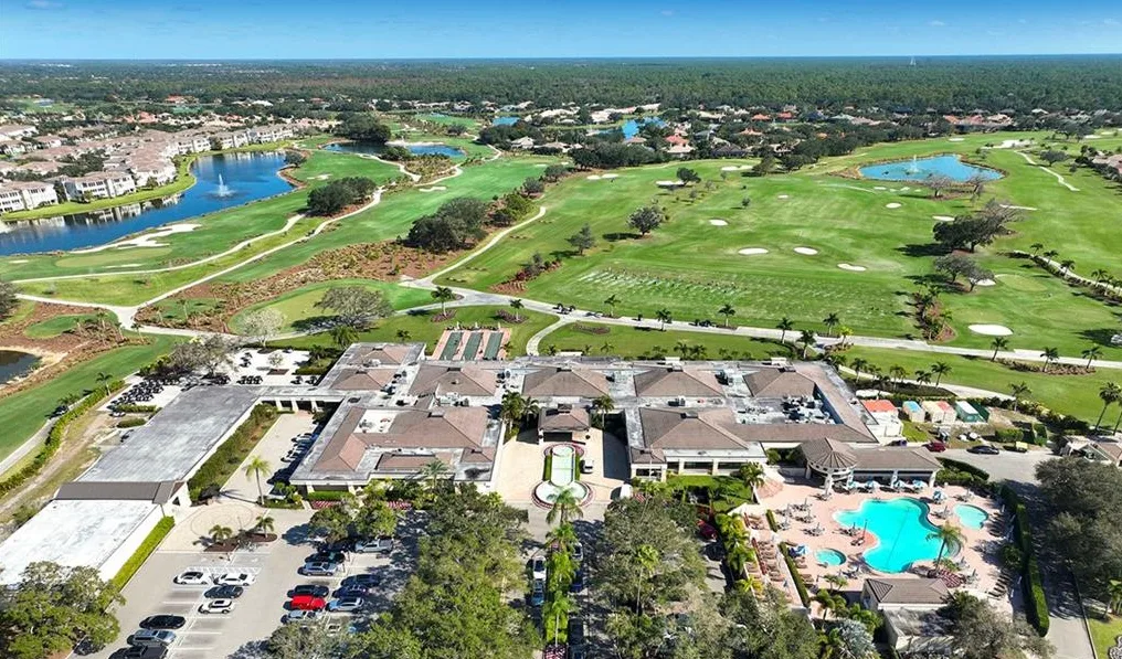 Wide aerial of the Vineyards Country Club clubhouse, golf course and lakes
