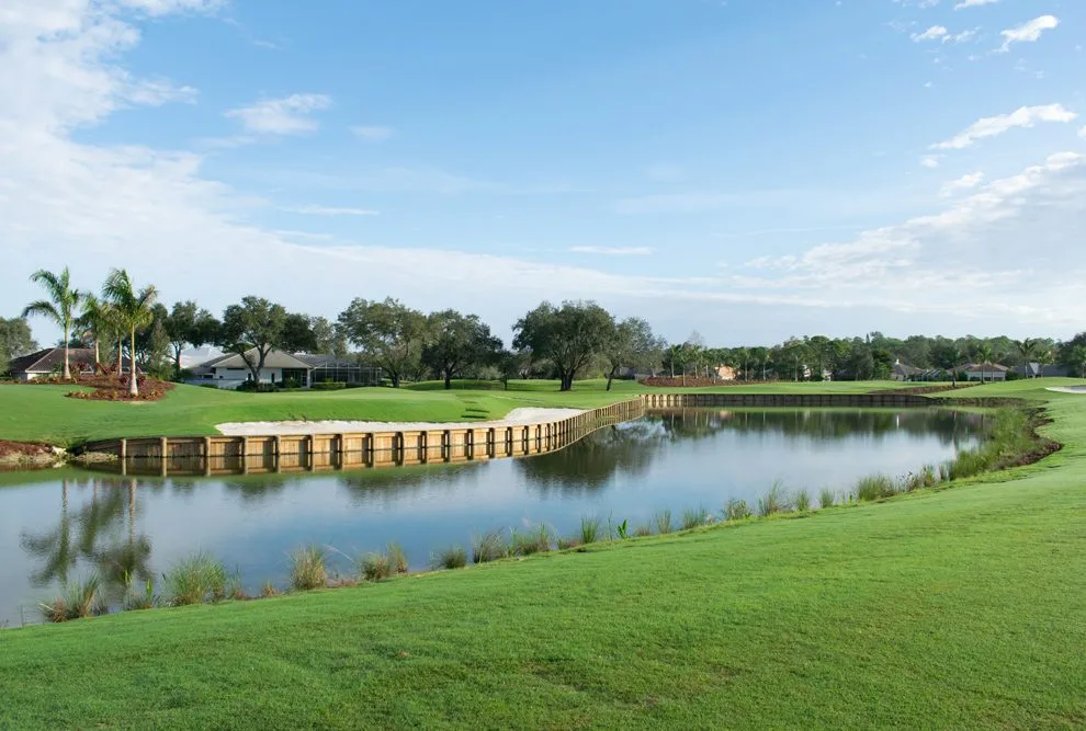 Green beside a lake on the South Course at Vineyards Country Club, Naples.