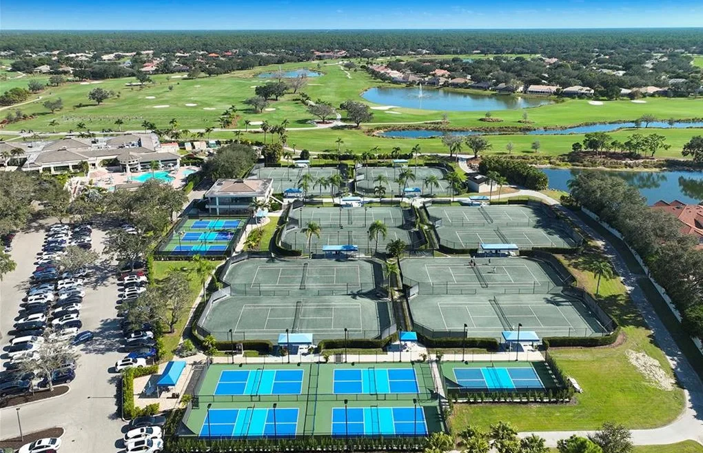 Vineyards Country Club tennis and pickleball courts beside the clubhouse, with golf and lakes