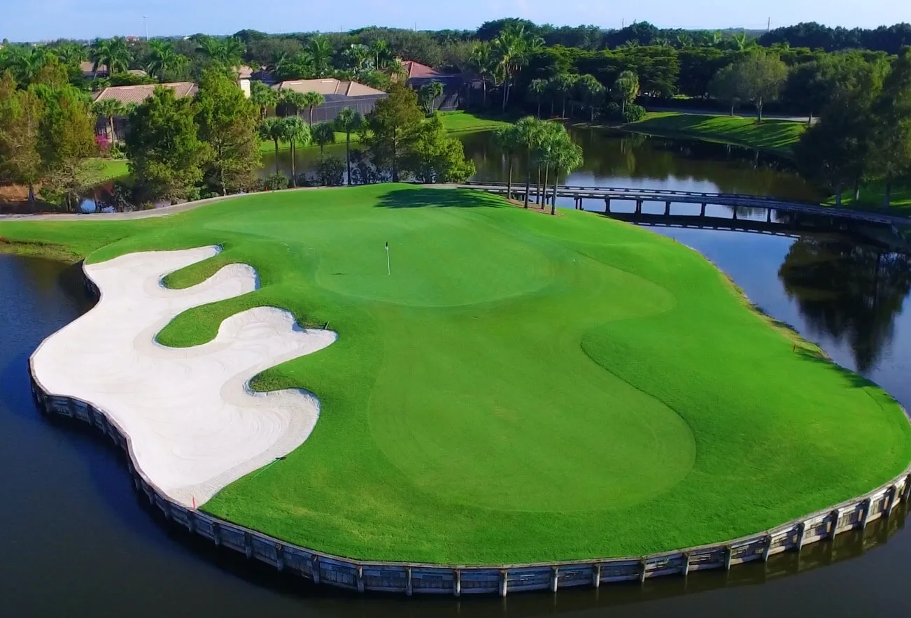 Aerial view of a bunkered green surrounded by water, Pelican Marsh Golf Club, Naples.