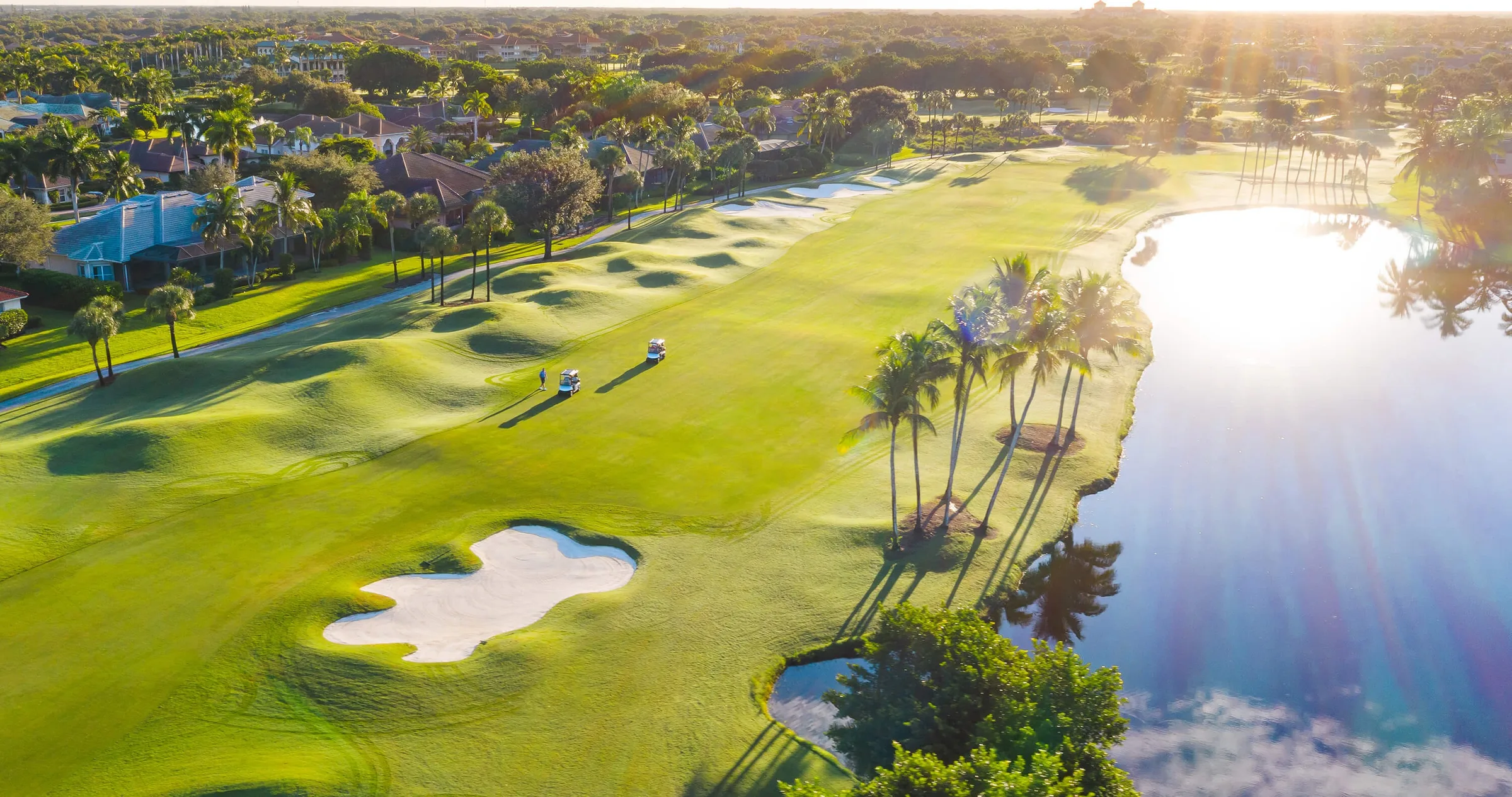 Aerial of a lakeside golf hole at Pelican Marsh, Naples (official club site).