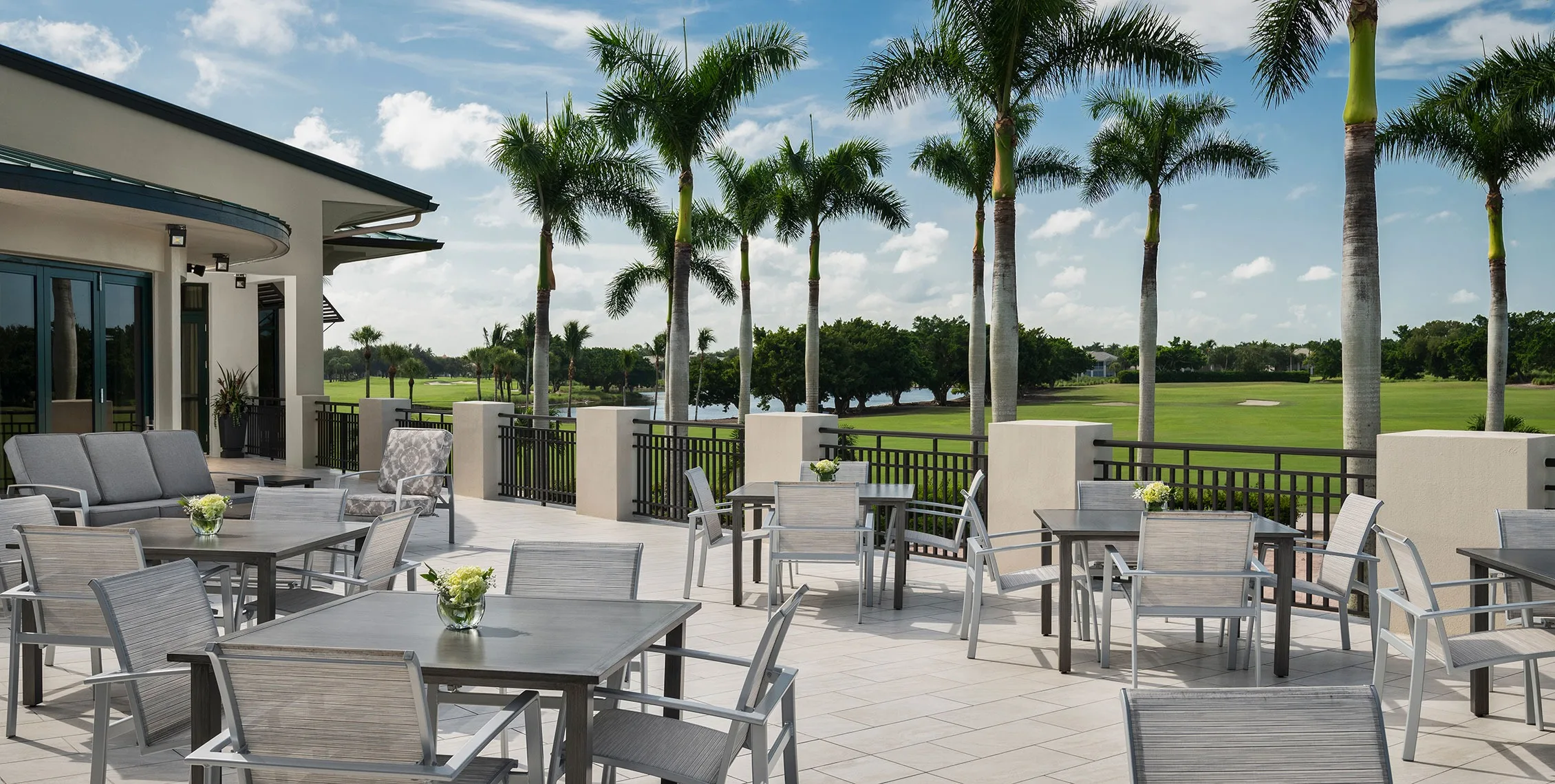 Outdoor dining terrace at the Pelican Marsh clubhouse, Naples (official club site).