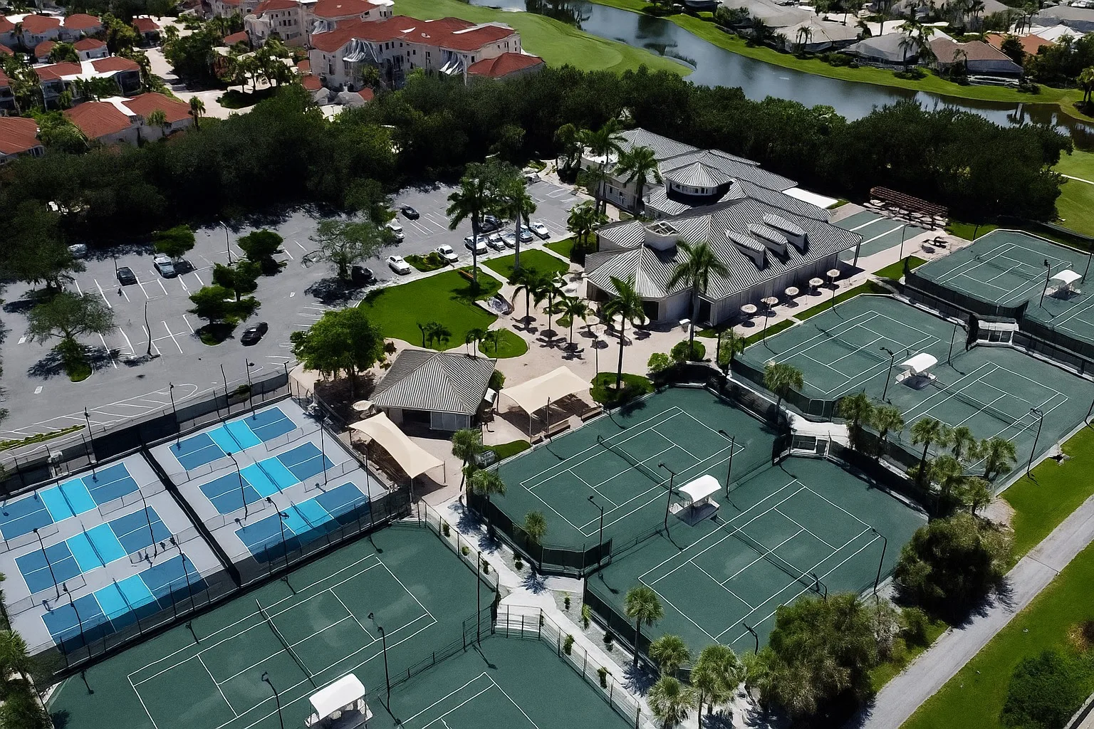 Aerial clubhouse tennis and pickleball complex at Pelican Marsh, Naples (official ClubEssential site).