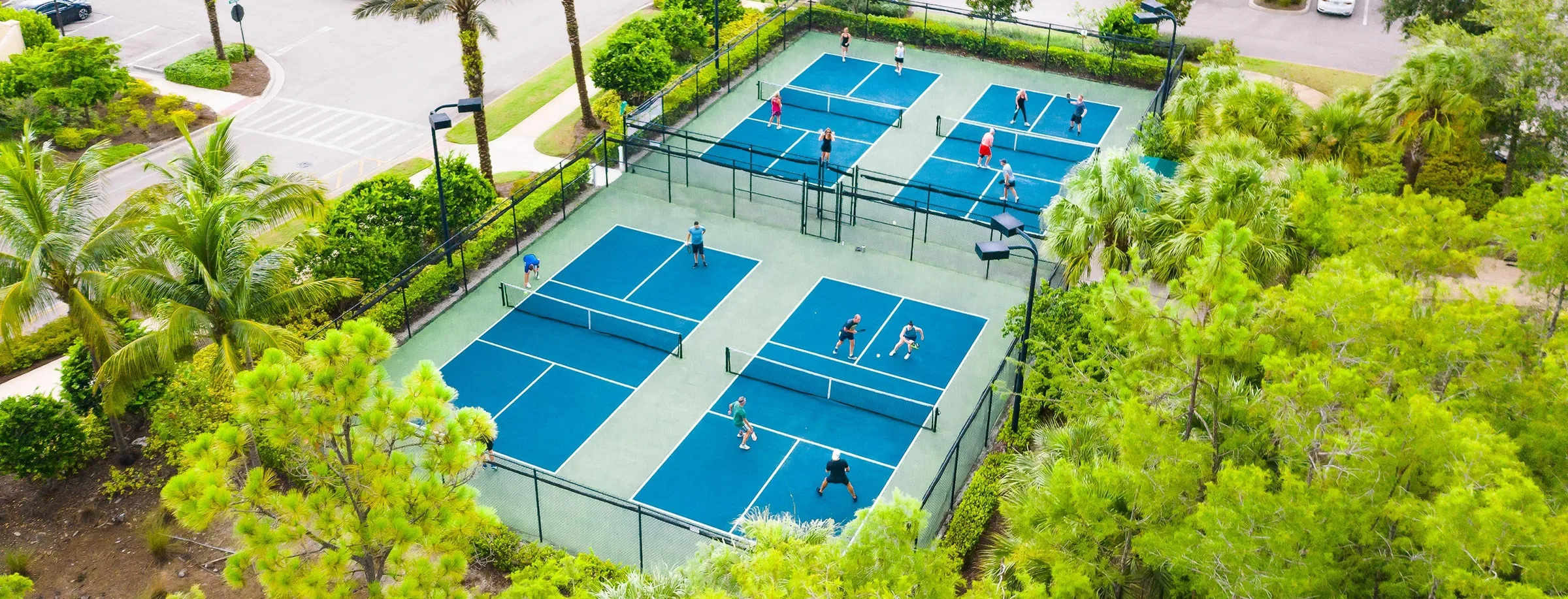 Aerial of the pickleball and tennis courts at Esplanade Golf and Country Club, Naples (official club site).