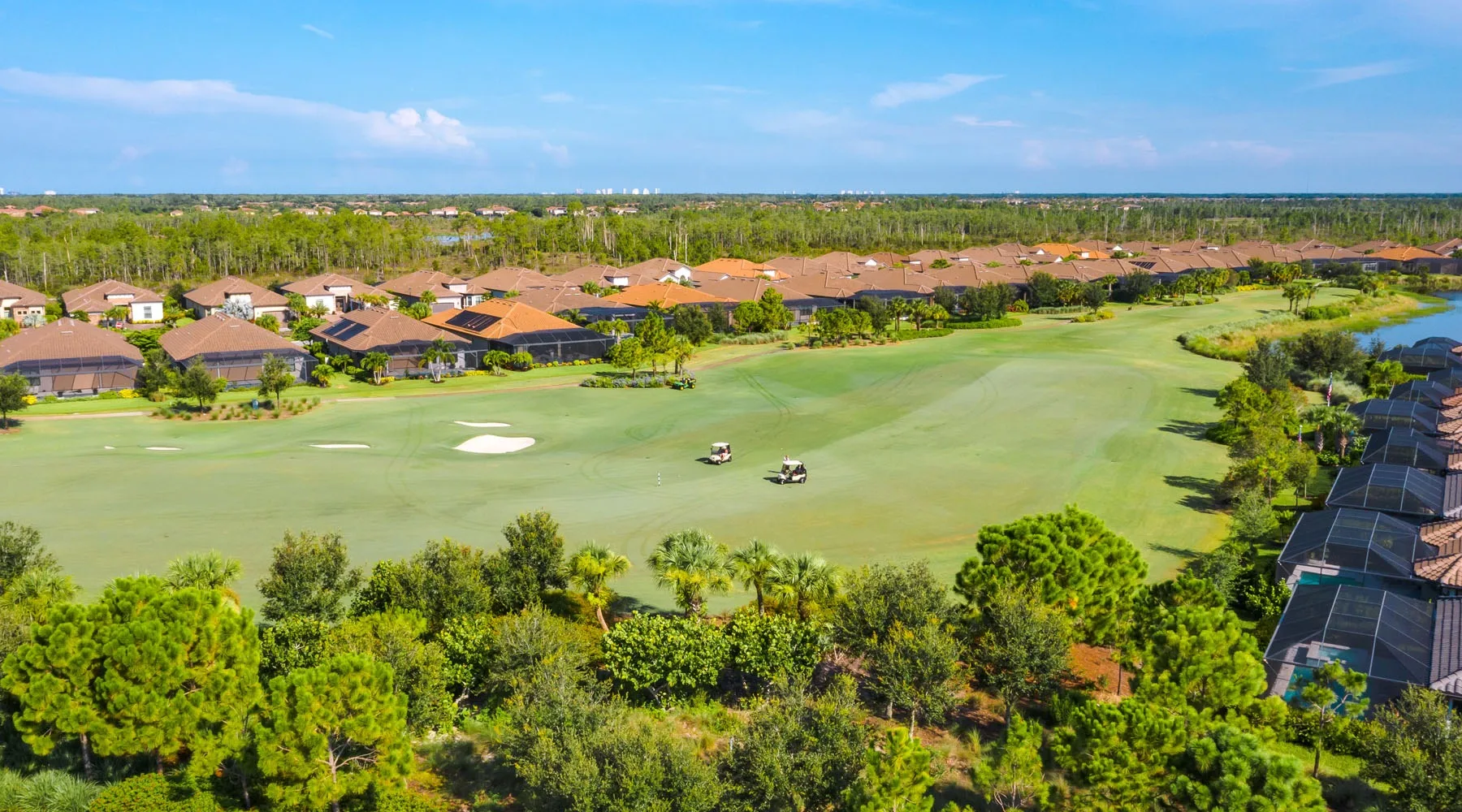 Aerial of a golf fairway lined with homes at Esplanade Golf and Country Club, Naples (official club site).