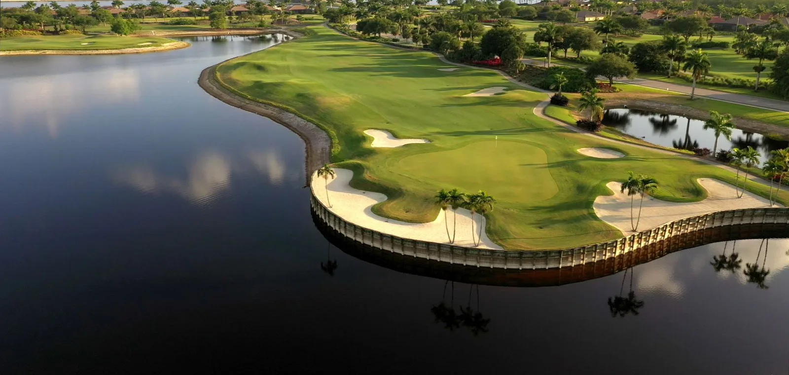 Aerial of a lakeside golf hole at Heritage Bay Golf and Country Club, Naples (official club site).