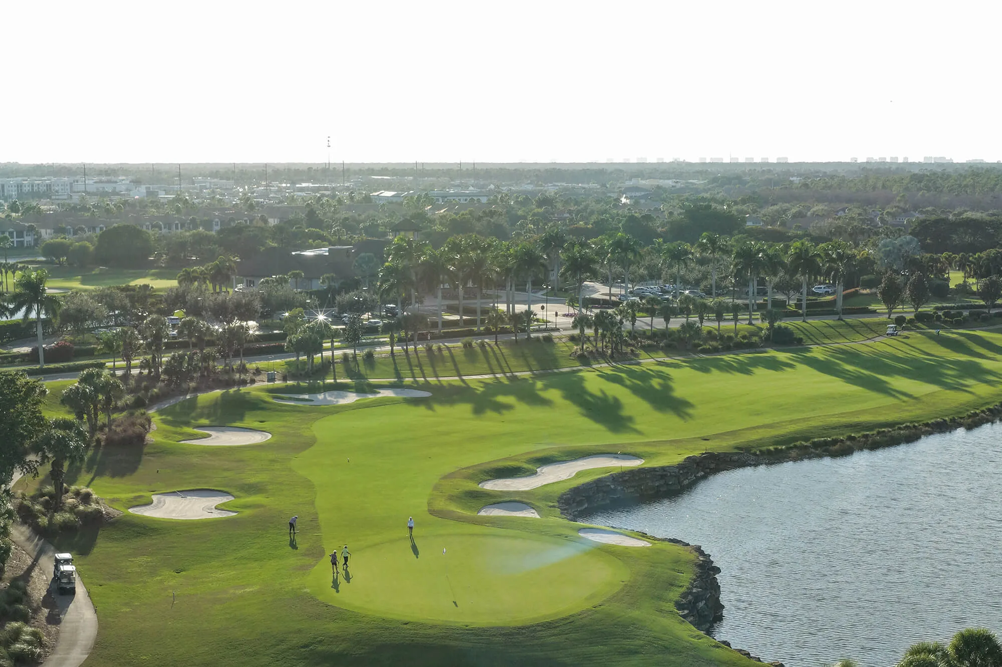 Aerial golf hole with lake at The Quarry Naples (official club site).