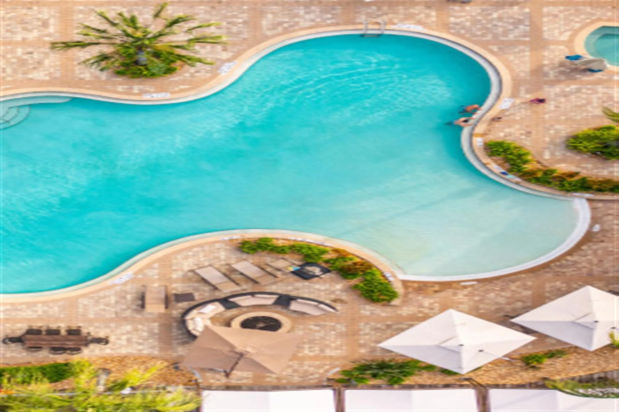 Aerial resort-style pool deck amenity at TwinEagles Club (official club site).