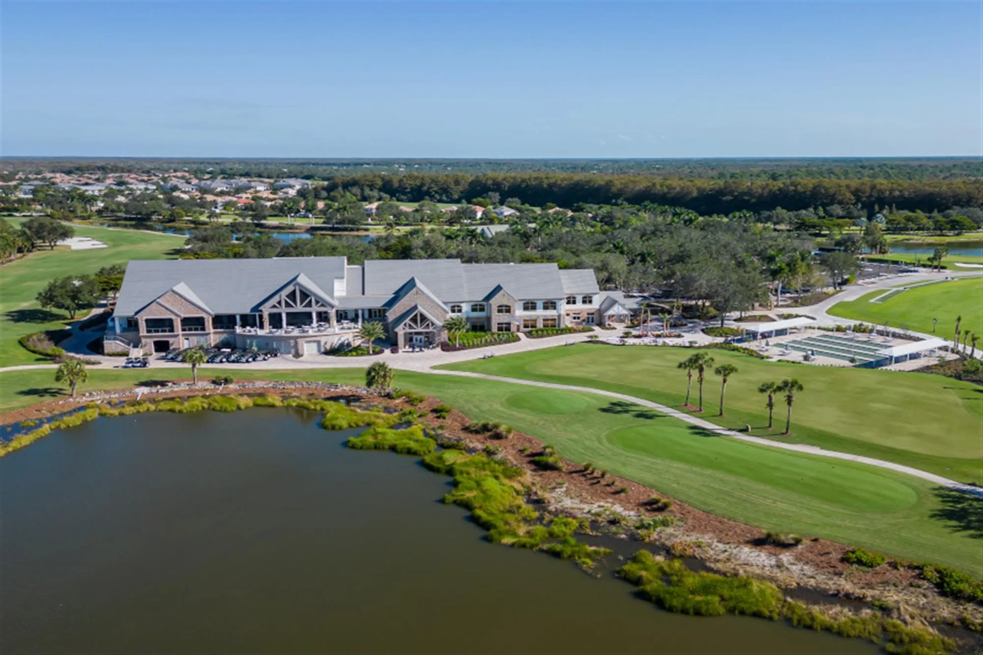 Aerial clubhouse golf and bocce courts at TwinEagles Club (official ClubEssential site).