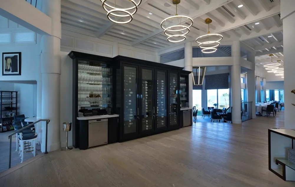 Bay Colony Beach Club dining room with a glass wine wall