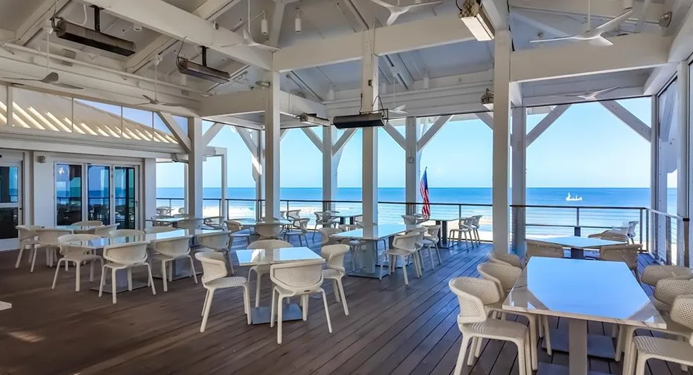 Open-air beachfront dining deck overlooking the Gulf in Pelican Bay