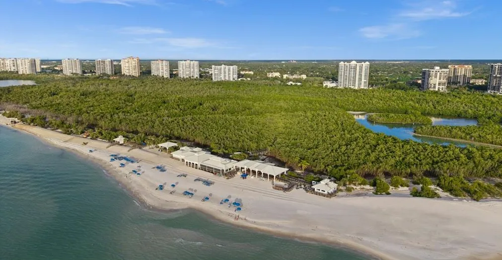 Aerial of a beach facility along the mangroves and the Gulf in Pelican Bay