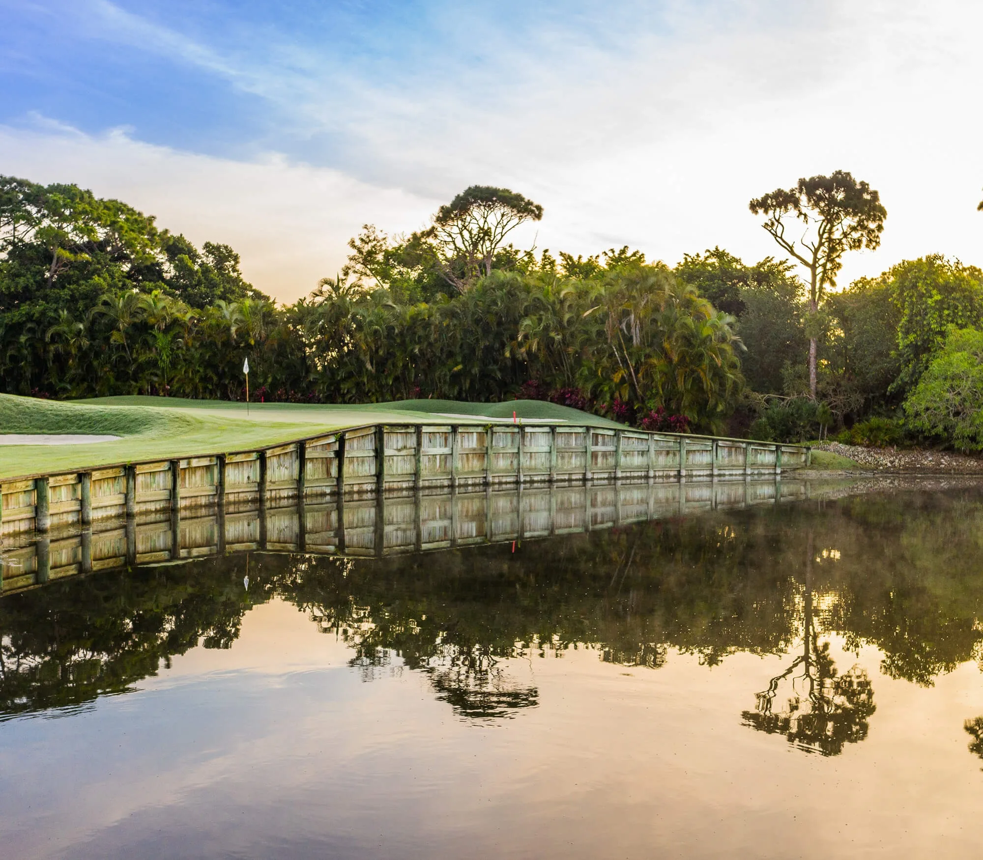 Golf cart bridge over a preserve pond at Audubon, Naples (official club site).