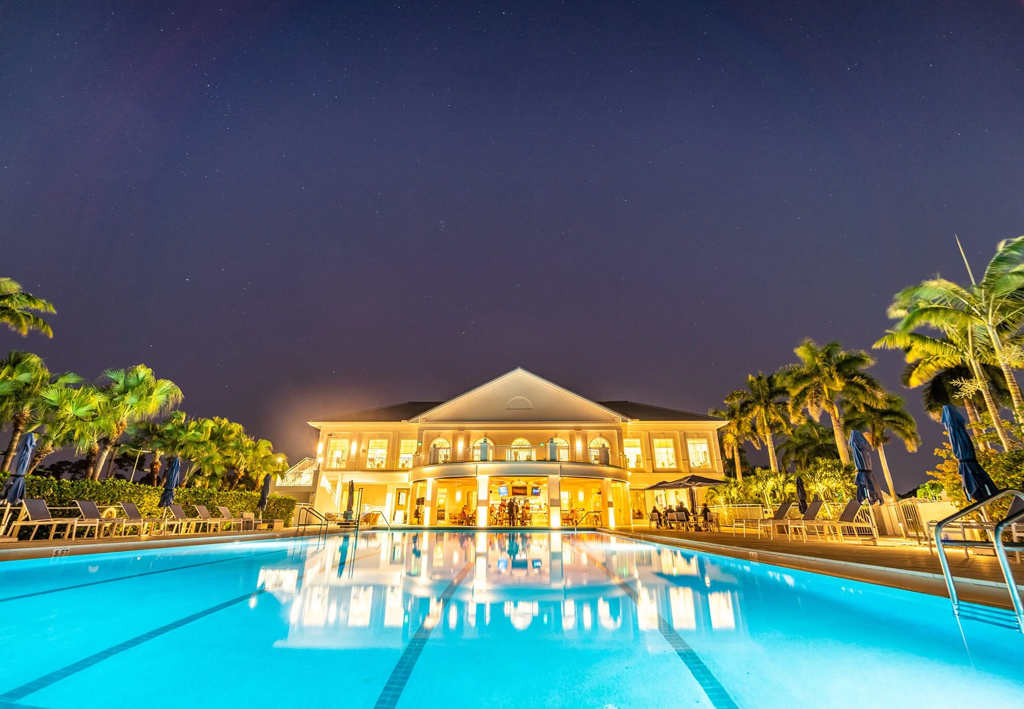 Clubhouse and pool at dusk, Audubon Country Club, Naples (official club site).